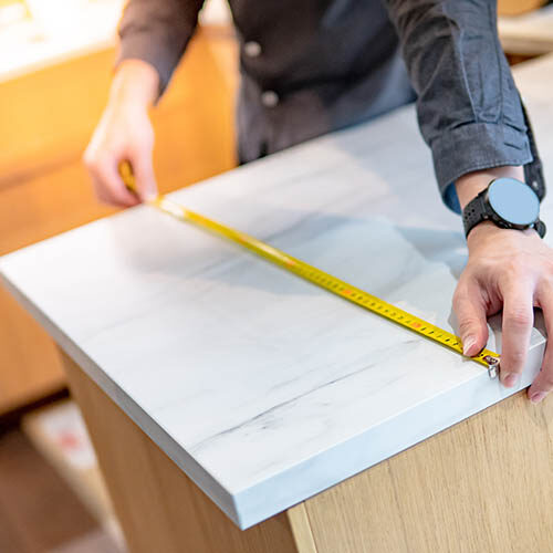 Man measuring countertop with measure tape | Color Interiors